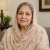 Portrait of a smiling elderly woman wearing a light headscarf